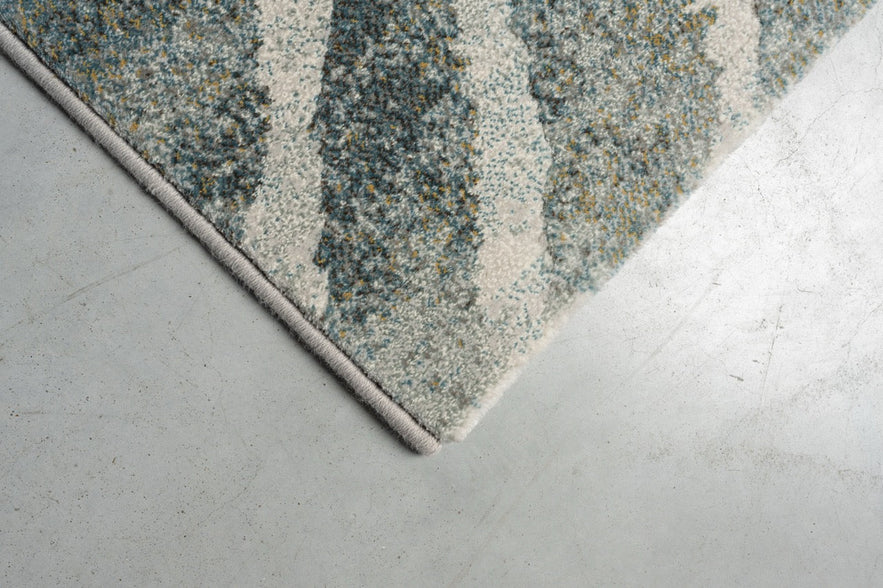 Eckdetail des Teppichs Tapison Home Torino 063.0990.4299 in Grün und Grau