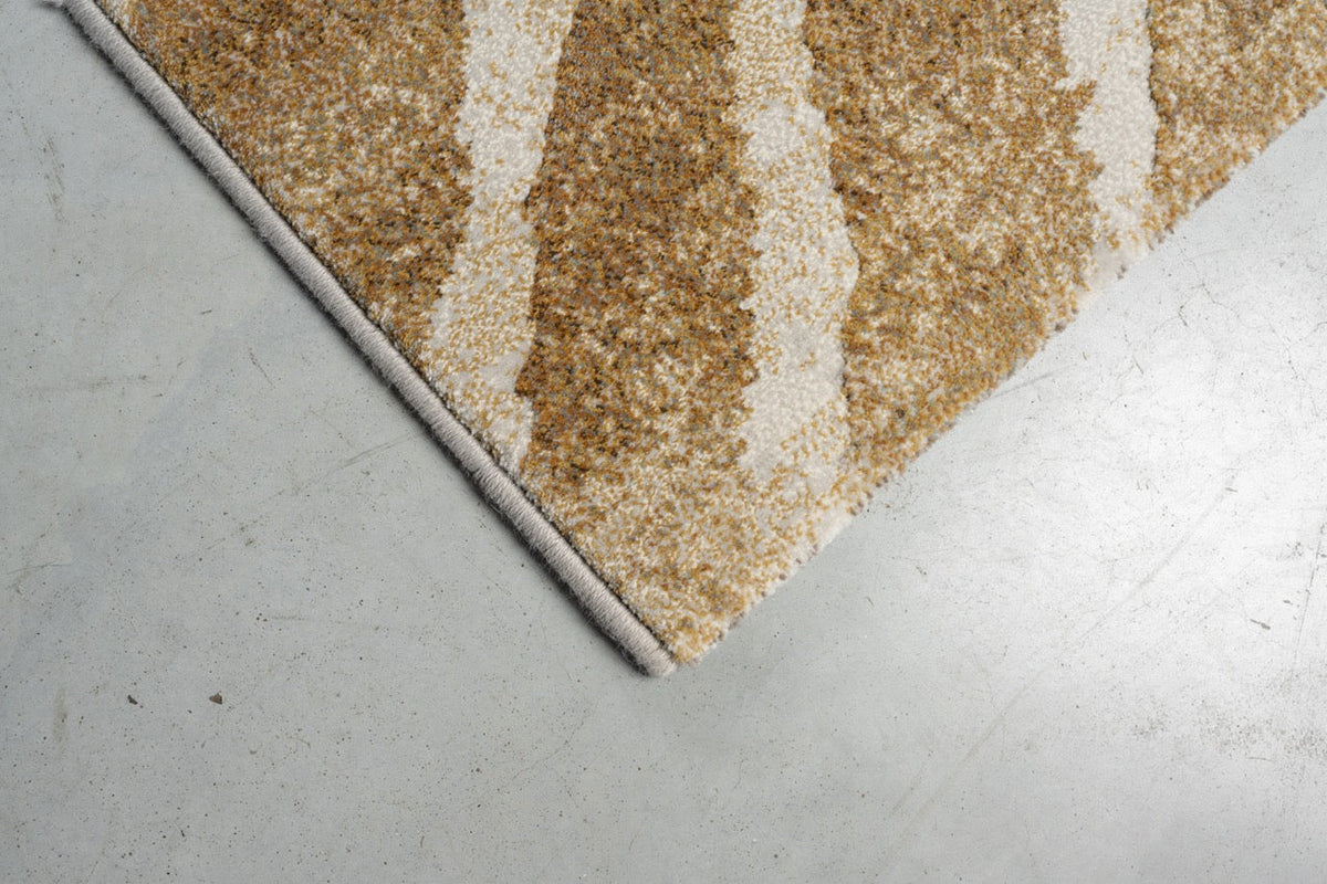 Eckdetail des Teppichs Tapison Home Torino 063.0990.7299 in Ocker und Elfenbein