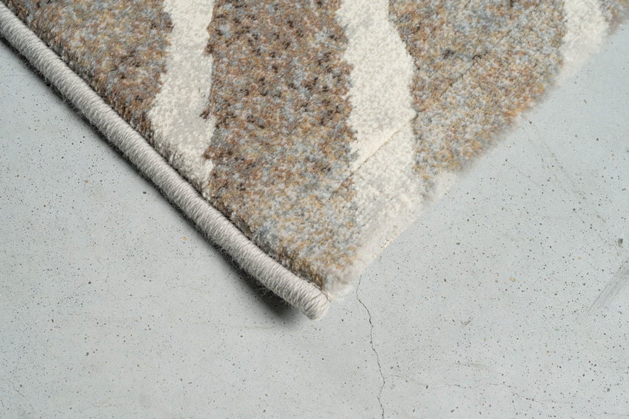 Eckdetail des Teppichs Tapison Home Torino 063.0990.9243 in Taupe und Elfenbein