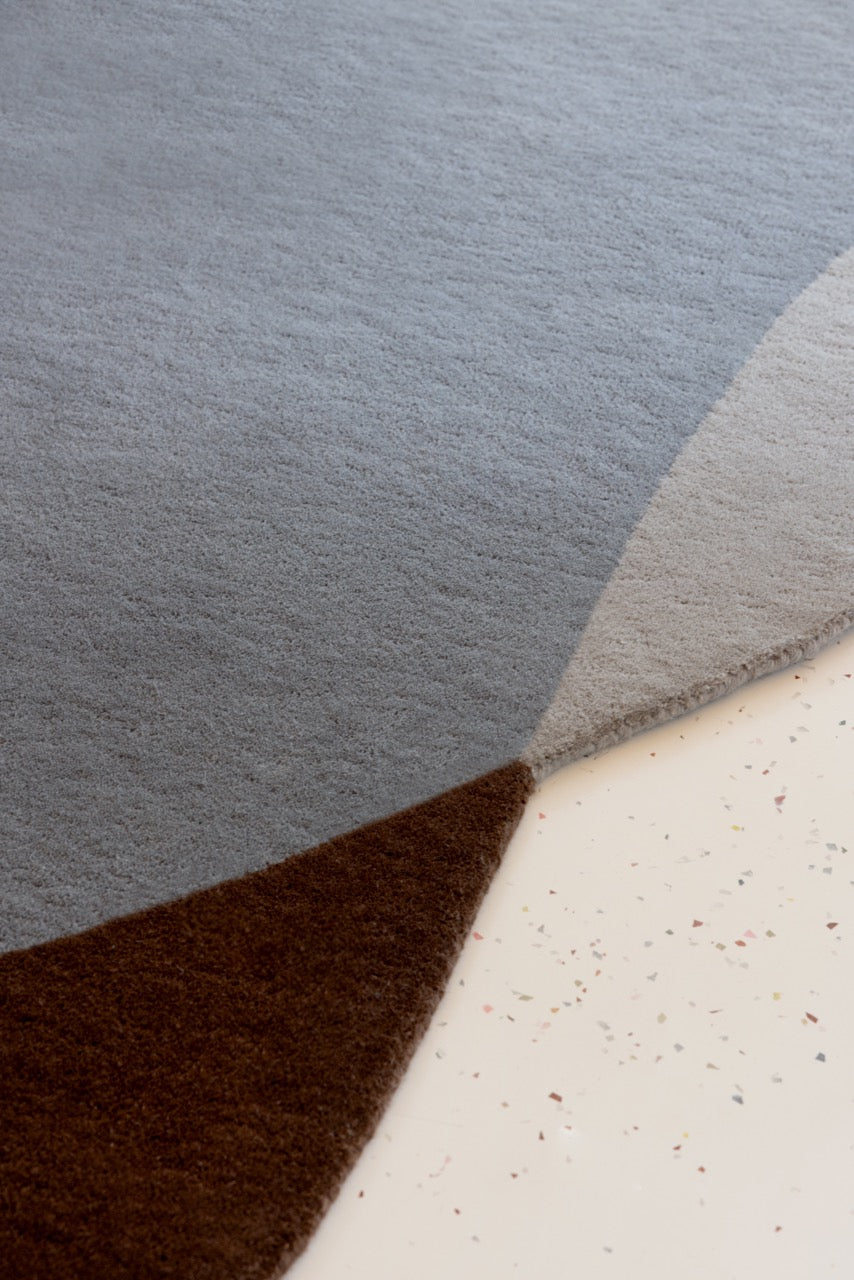  Close-up of hand-tufted wool texture in brown and blue tones