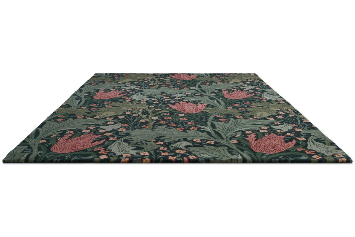 Morris & Co Lent Lily Indigo Madder Teppich in Indigo mit krapproten Tulpen und salbeigrünen Blättern, Schrägansicht