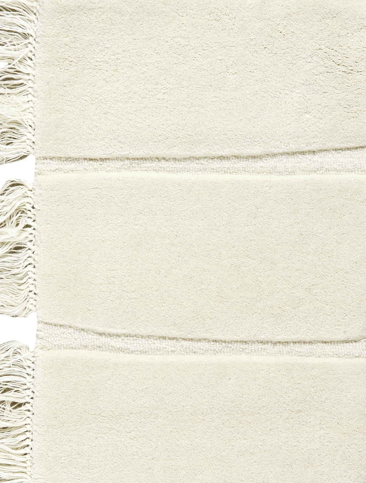 Massimo Atoll Cream cremefarbener Teppich, Detail der Fransen